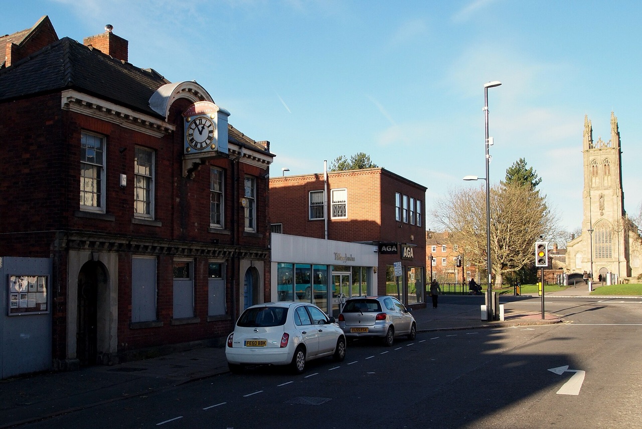 A street in Derby's Cathedral Quarter with the tower of Derby Cathedral in the distance