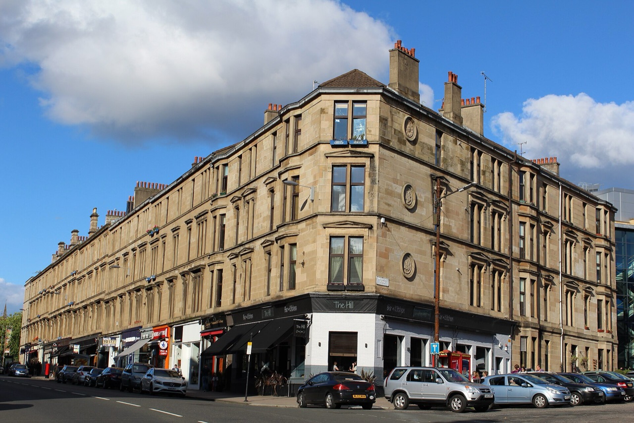 A sandstone tenement on the corner of Byres Road and University Place in Glasgow's West End
