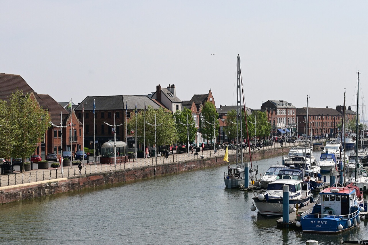 Boats moored in Hull Marina, with brick buildings and trees along the quayside