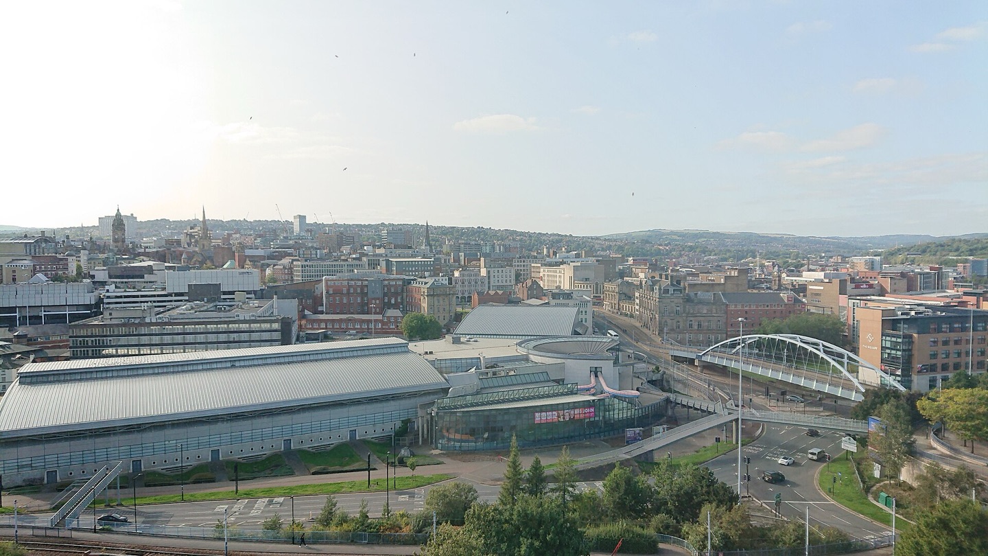 Sheffield city centre seen from Park Hill, with the railway station and the city spread across the hills beyond