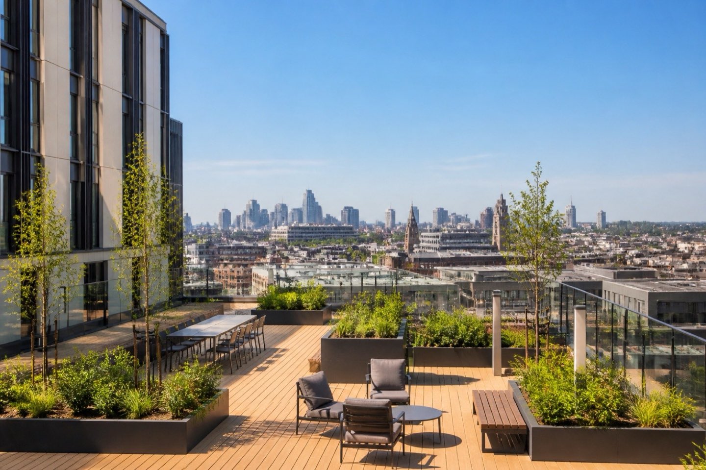 A rooftop terrace on a student accommodation building with a city skyline